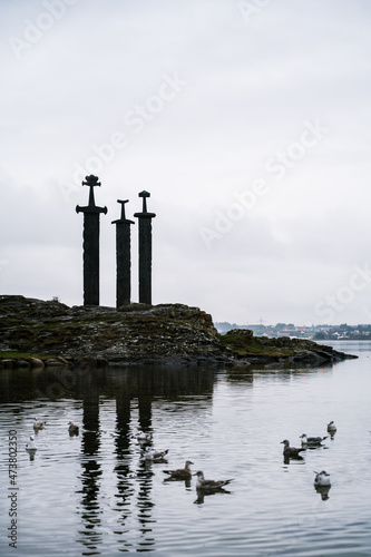Swords in Rock (Sverd i fjell),  monument in Hafrsfjord neighborhood of Madla, Stavanger. Cloudy rainy day in Norway. Seagulls in water.