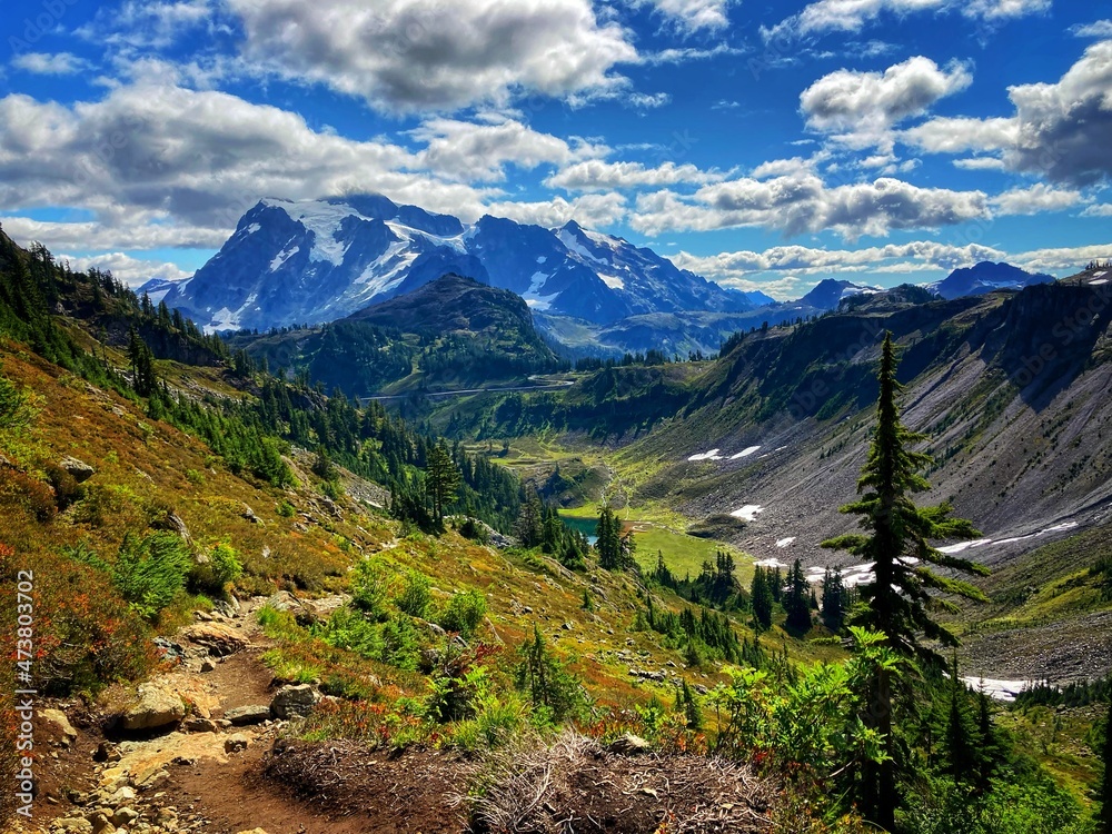 mountains with blue sky and white clouds and green pines mountains with blue sky and white clouds and green pines