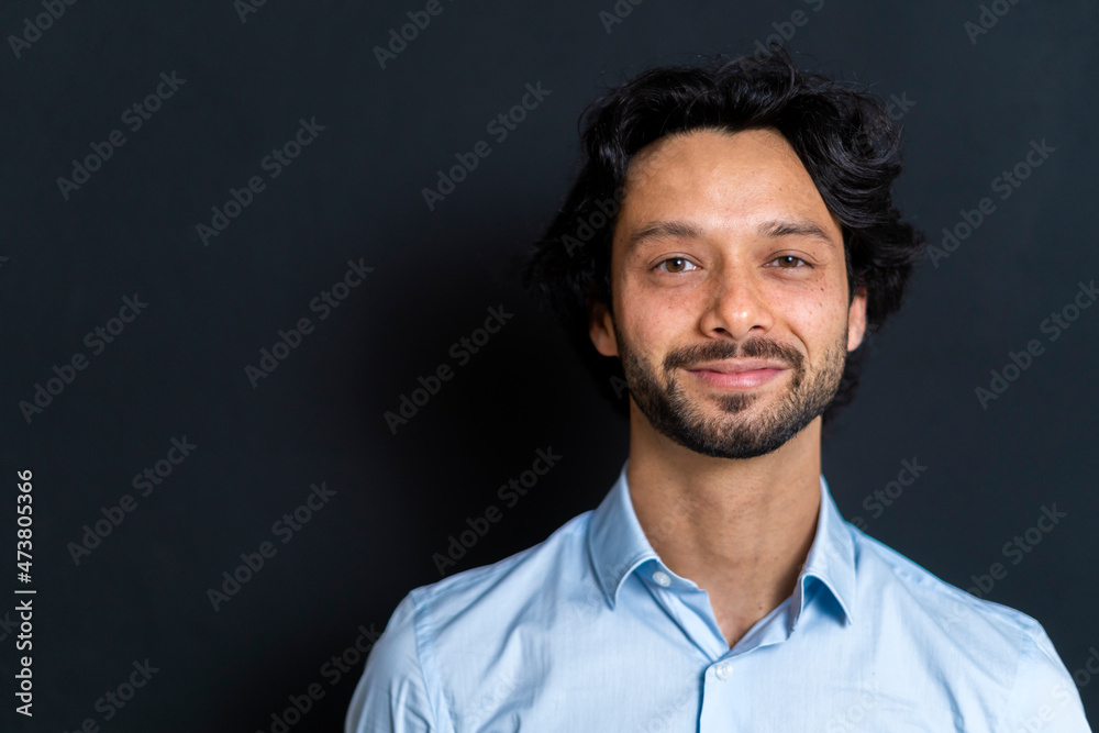 Male entrepreneur smiling against black background Male entrepreneur smiling against black background