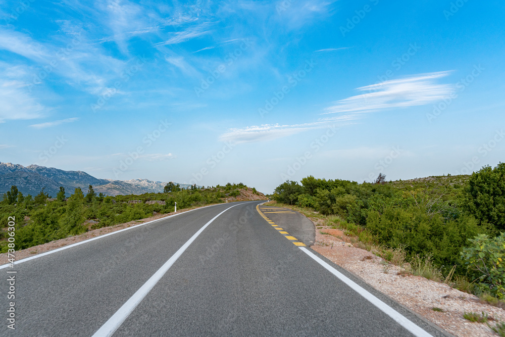 Scenic road. The road is surrounded by a magnificent natural landscape.