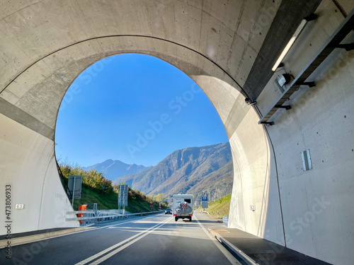View through highway tunnel onto Swiss mountains.