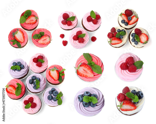 Set with delicious cupcakes on white background, top view