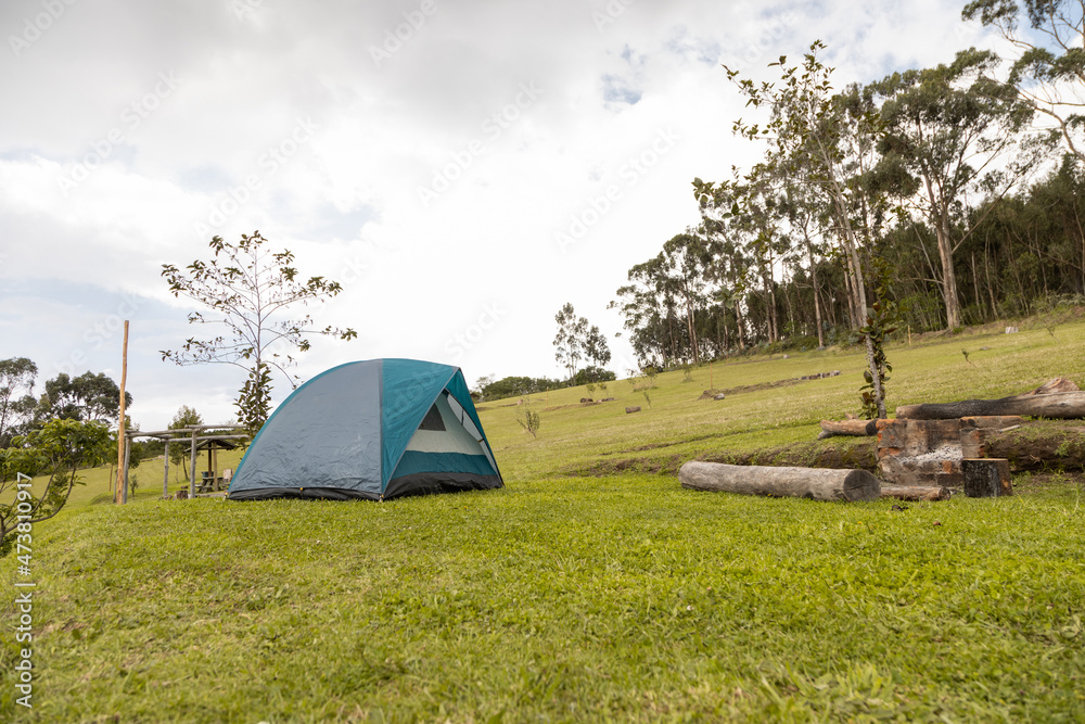 landscape with tent on grass with trees in the background, pastime in the middle of nature, outdoor and lifestyle, objects for camping in park