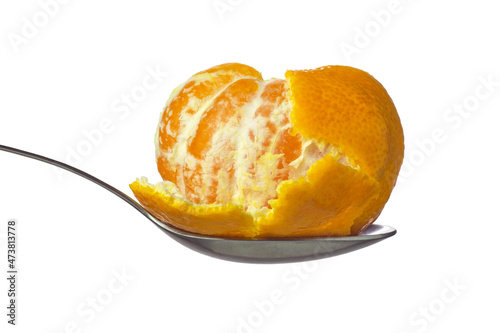 Whole mandarin with peel in spoon isolated