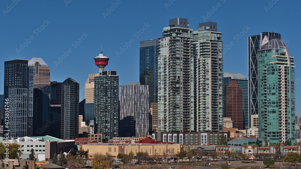 Beautiful view of the downtown of Calgary, Alberta, Canada with skyline of modern high-rise buildings on sunny day in autumn season with blue sky.