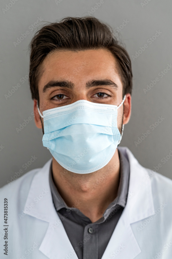 Male healthcare worker wearing protective face mask during COVID-19 Male healthcare worker wearing protective face mask during COVID-19