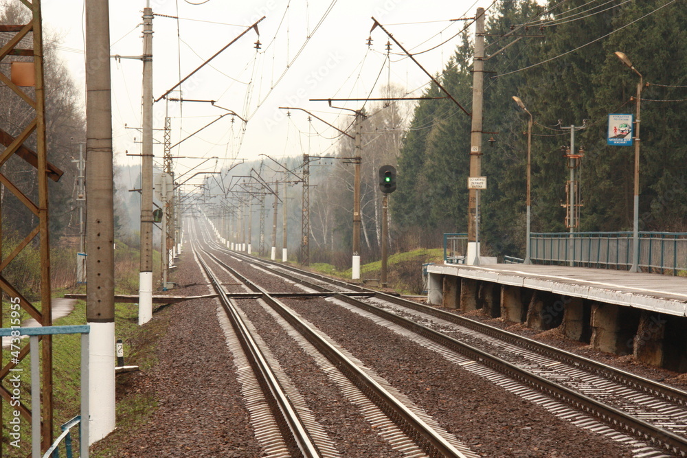 Empty railway at a countryside station in a cloudy day