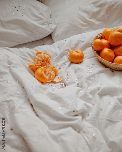 woman with mandarins and mobile phone at home