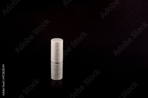 silver matte lipstick bottle on black background side view