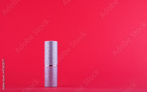 Silver lipstick matte on red background side view