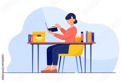 Book lover sits by table