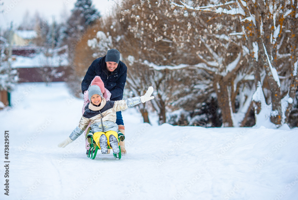 Family of dad and kids vacation on Christmas eve outdoors Family of dad and kids vacation on Christmas eve outdoors