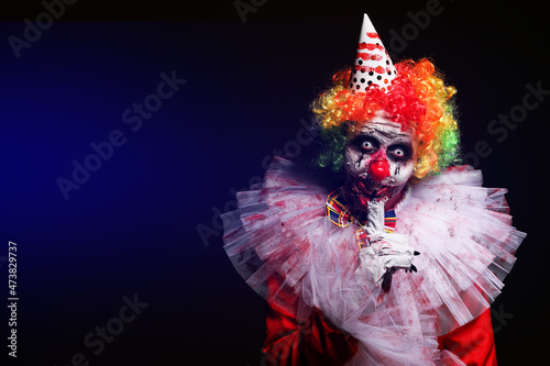 Wallpaper Mural Terrifying clown on dark background, space for text. Halloween party costume Torontodigital.ca