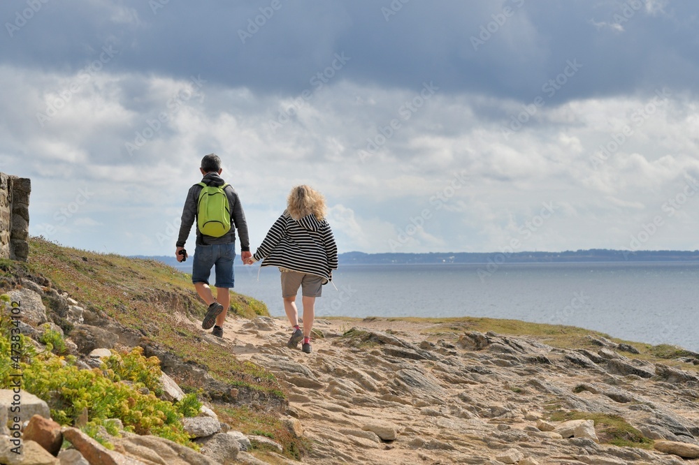 People,walking along the wild coast at the Quiberion peninsula in Brittany France