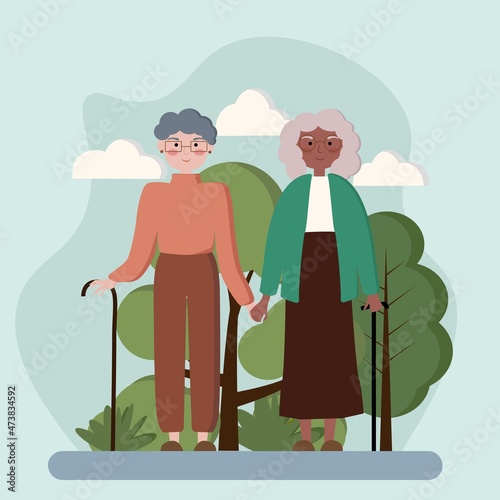 Couple of happy multiracial grandmothers walking holding hands