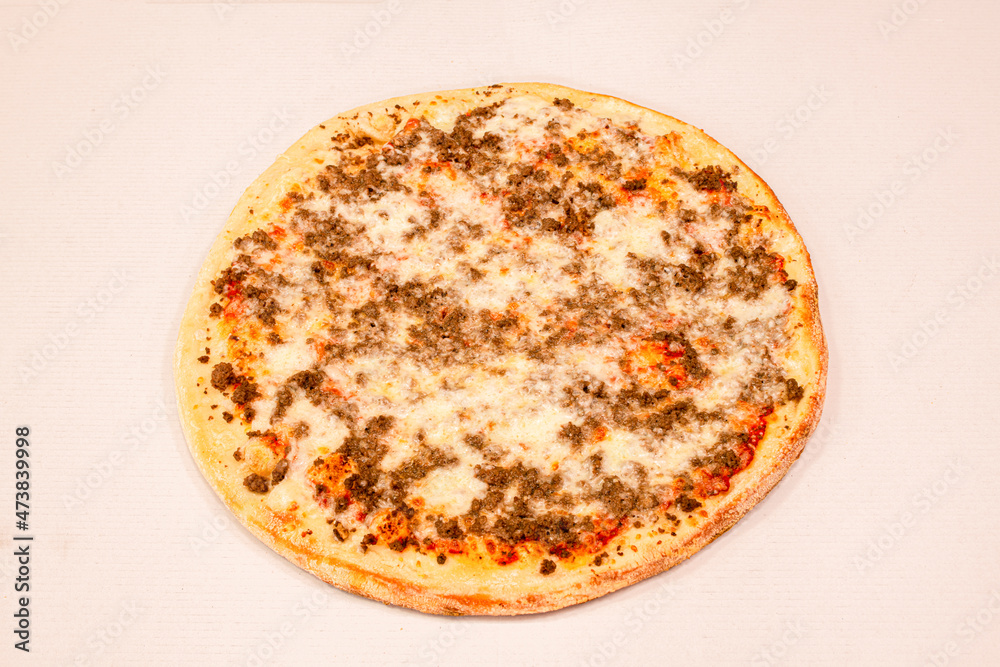Pizza of minced beef stewed with lots of mozzarella cheese and grated cheese with tomato baked on stone Pizza of minced beef stewed with lots of mozzarella cheese and grated cheese with tomato baked on stone