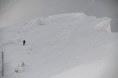 magnificent view of snow-covered mountain slope with skier on it