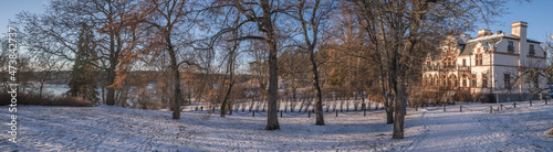 Snowy panorama view over a castle on a hill a sunny pale winter day with snow in Stockholm
