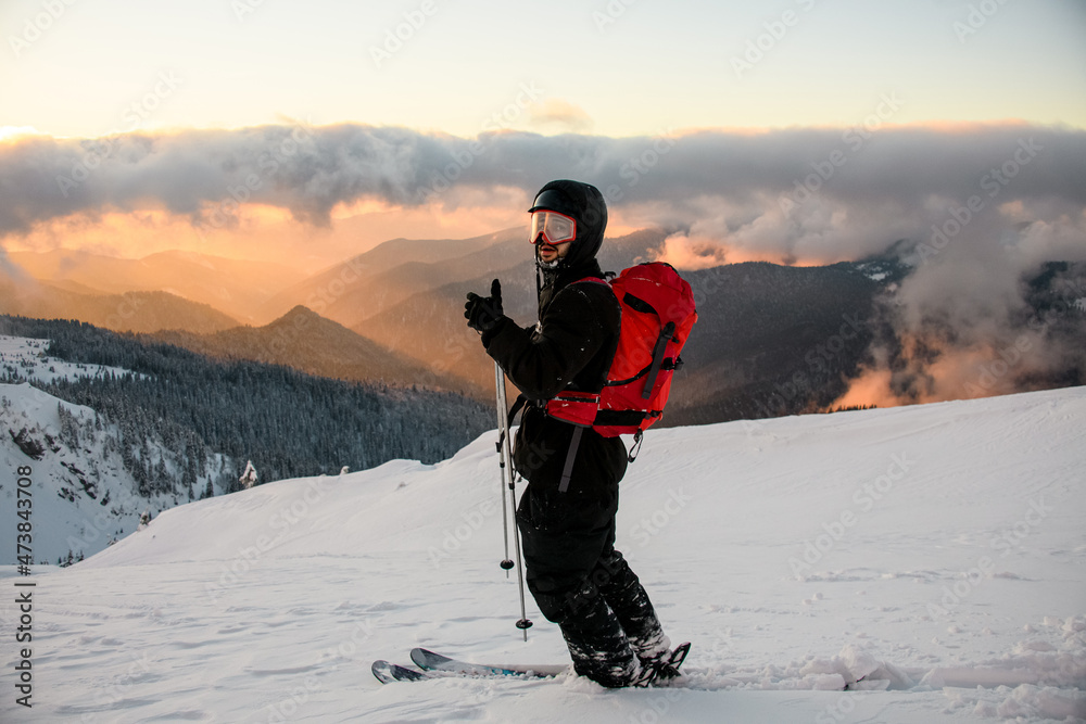 beautiful view of the of male ski rider against the backdrop of mountains and sky