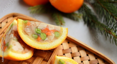 Schilderij op canvas appetizer of jellied chicken with vegetables in orange close up selective focus