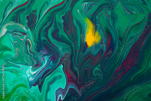 Beautiful liquid texture of the nail polish.Green and purple colors.Multicolored background with copy space.Fluid art,pour painting technique.Good as digital decor.