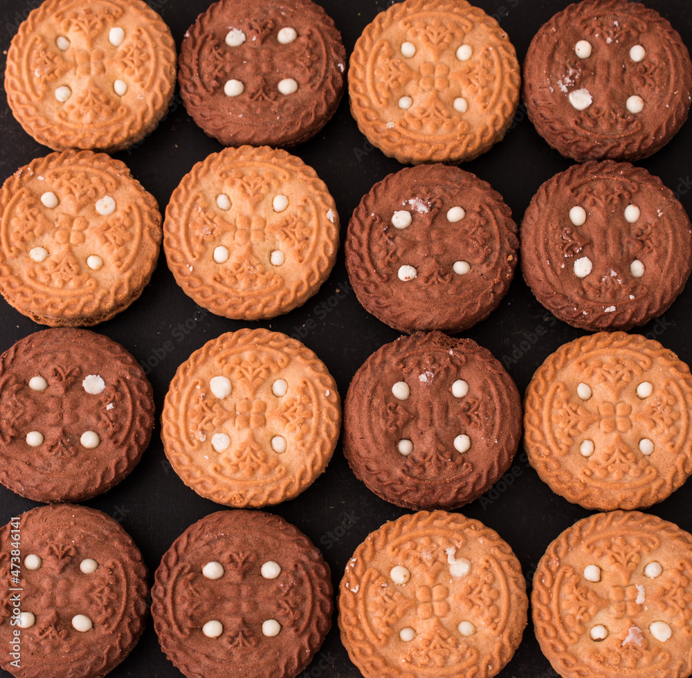 Some different cookies on a black wooden table Some different cookies on a black wooden table