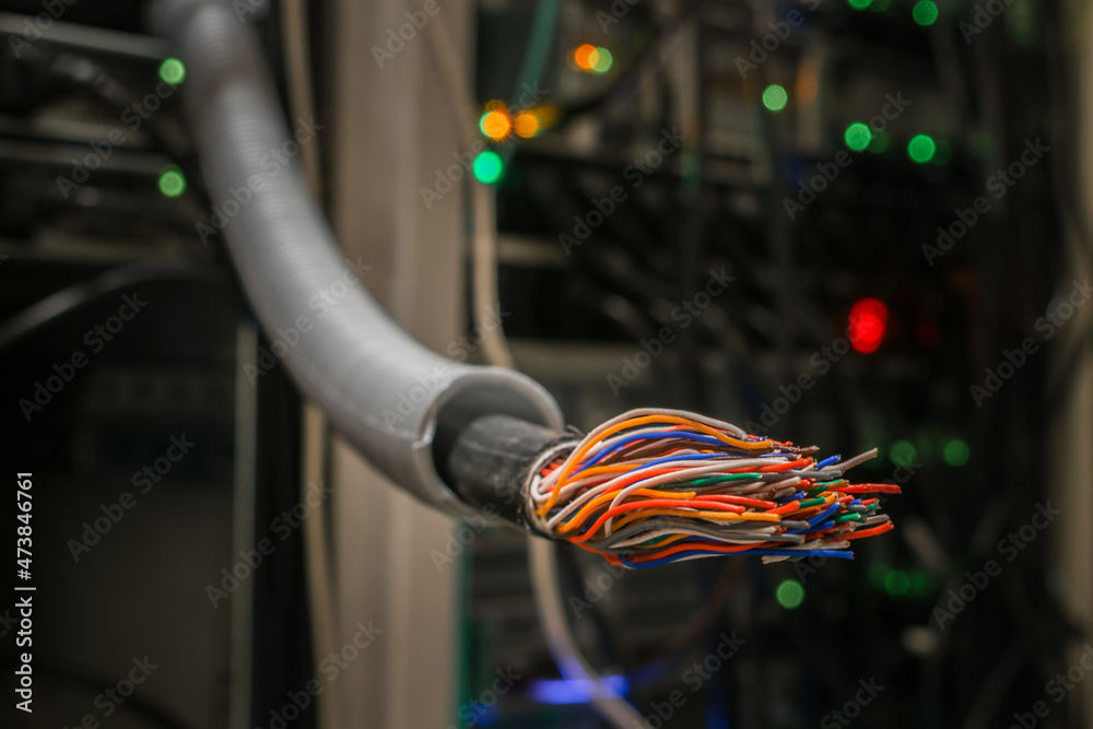 There is a damaged stranded trunk cable in the server room. Breakage in the communication wire - obrazy, fototapety, plakaty 