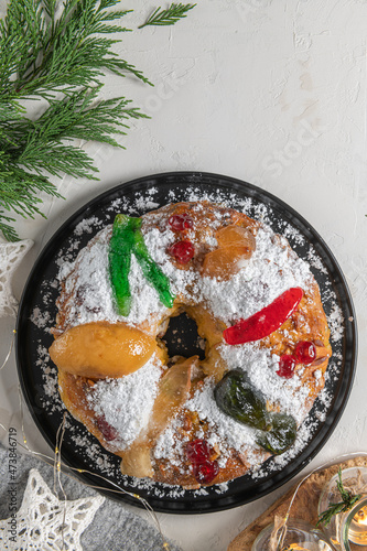 Bolo Rei or King's Cake is a traditional Xmas cake with fruits raisins nut and icing  on kitcthen countertop. Is made for Christmas, Carnavale or Mardi Gras photo