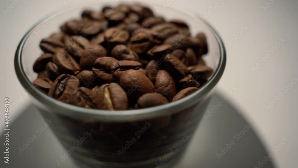 Panoramic shot of a glass cup with fragrant coffee beans. Coffee as a toning drink. The benefits and harm from the use of coffee. Panoramic shot of a glass cup with fragrant coffee beans. Coffee as a toning drink. The benefits and harm from the use of coffee.