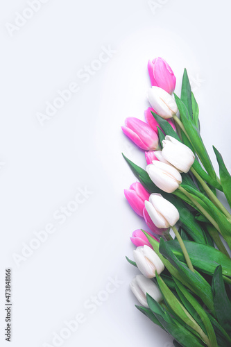 Fototapeta Naklejka Na Ścianę i Meble -  Pink and white tulips on white background and copy space.