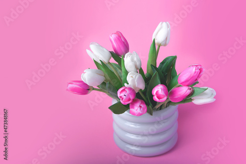 Fototapeta Naklejka Na Ścianę i Meble -  Pink and white tulips in white vase close up and copy space.