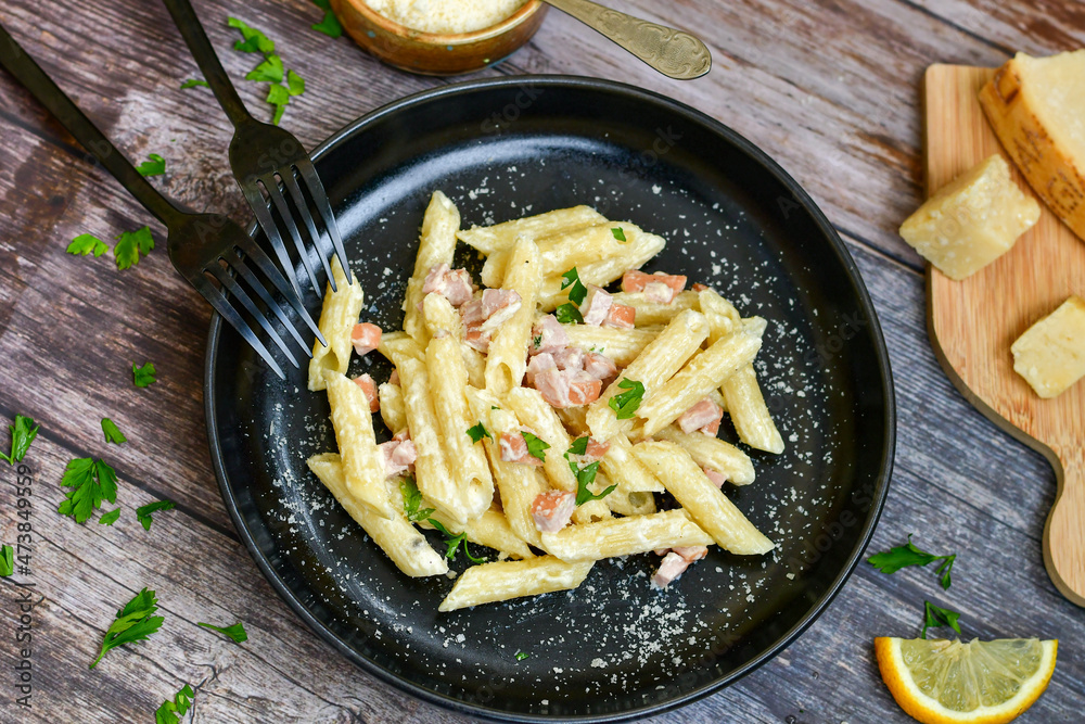Fresh home made italian penne pasta alla carbonara with cream sauce , bacon,egg, parmesan cheese ,olive oil and black pepper) Fresh home made italian penne pasta alla carbonara with cream sauce , bacon,egg, parmesan cheese ,olive oil and black pepper)