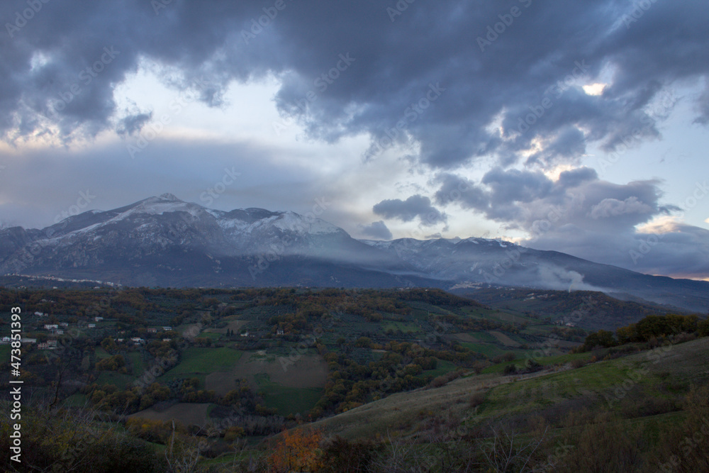 View of the Majella mountain in Abruzzo Italy with snowy peak and sky with clouds