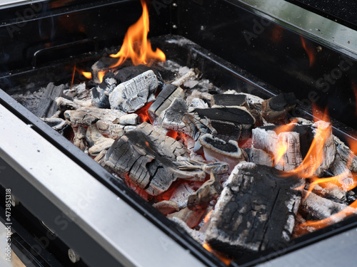 Burning charcoal in a grill