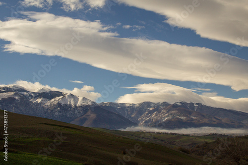 View of the Majella mountain in Abruzzo Italy with snowy peak and sky with clouds