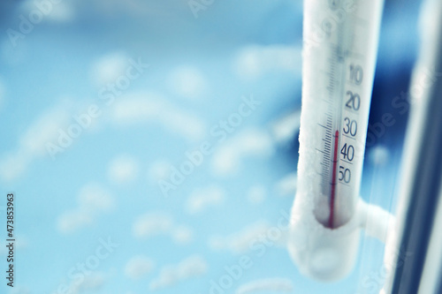 Classic mercury thermometer for measuring ambient temperature, hanging outside the window, with readings minus 30 degrees Celsius.