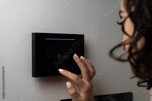 woman controlling the door with smart home systems