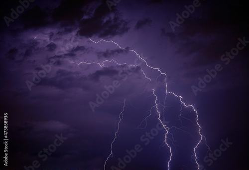 Night lightning thunderbolt over the sky in blue background