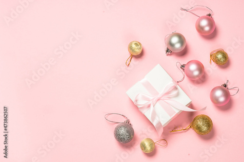 Christmas pink flat lay background with present box and decorations. Minimal style patel colors.