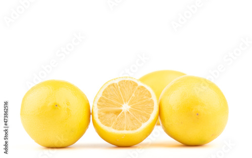 Half lemon and whole lemons on a white background.