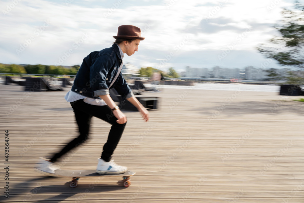 Melinial hipster man riding speed on a skateboard walking in the city alone, blurry photo in motion. Melinial hipster man riding speed on a skateboard walking in the city alone, blurry photo in motion.