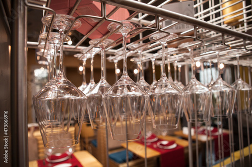 Close up of a stemware rack at restaurant full of clean glasses © Ihor
