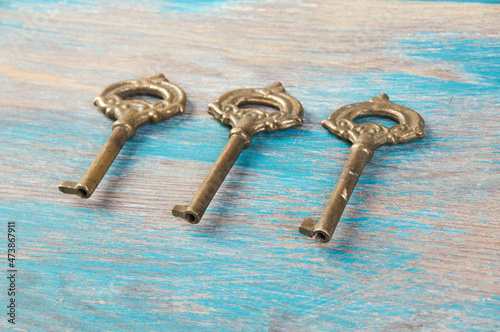 Old meal keys on wooden background photo