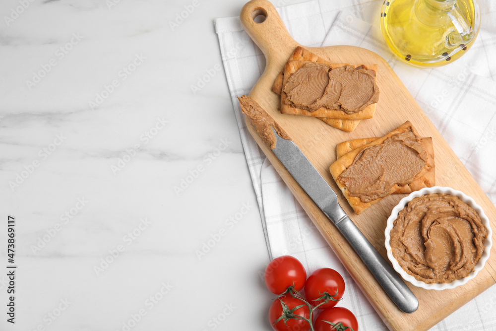 Crispy crackers with delicious meat pate served on white marble table, flat lay. Space for text Crispy crackers with delicious meat pate served on white marble table, flat lay. Space for text