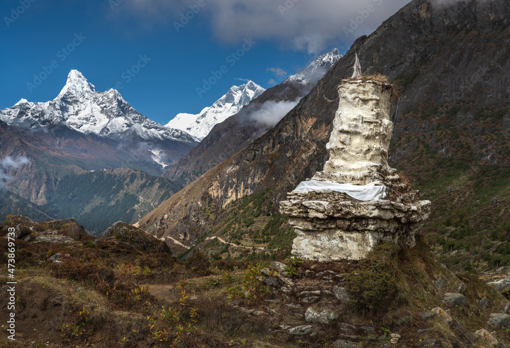 ancient buddha stupa in valley with view to summit Ama Dablam in Nepal