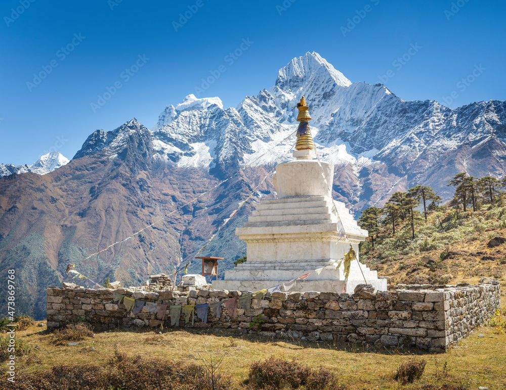 big white buddhist stupa (pagoda) in valley Khumbu with view to Himalaya mountains in Nepal