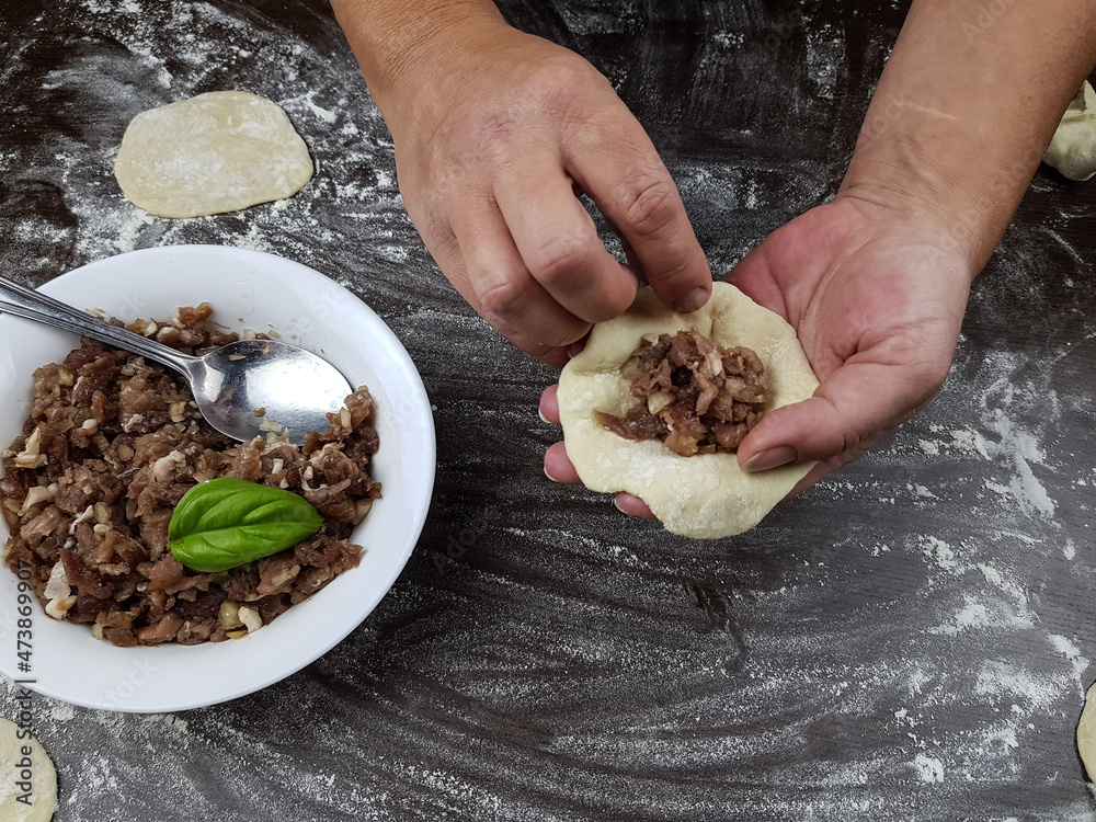 prepare manti stuffed with meat dough for khinkali dumplings or dumplings. preparation of dough and meat dishes
