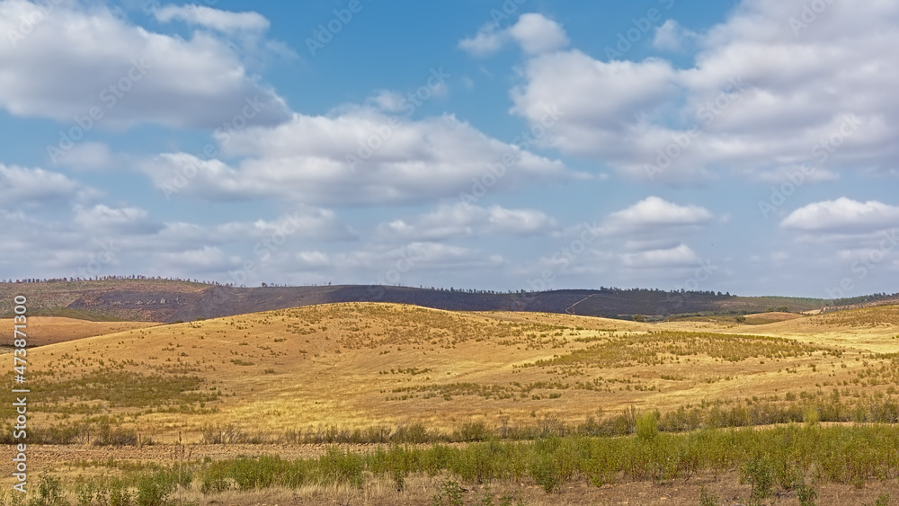 Landscape with barren hills and valley of the Spanish countryside on a suny day withh soft clouds in la Codosera, Extremadura, Spain, Europe
