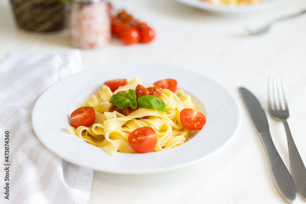 Fresh Italian pasta with cherry tomatoes, cheese and basil. Vegetarian spaghetti. Healthy food.