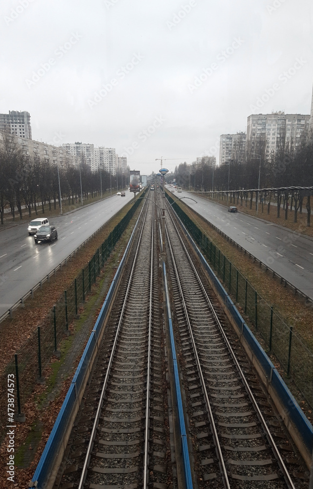 Fototapeta premium The rails of public transport in the city going into perspective are photographed from a high angle